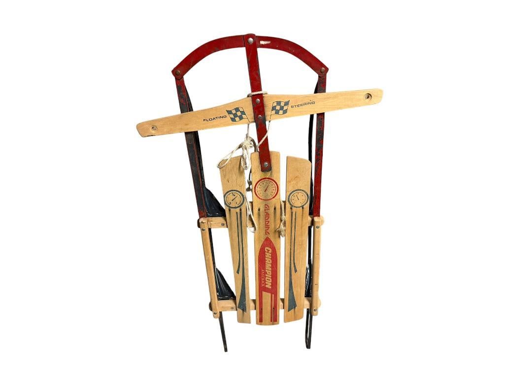 VINTAGE GLADDING CHAMPION FASTBACK SNOW SLED WITH FLOATING STEERING DESIGN: WOOD SLATS WITH RED PAINTED METAL FRAME, GOOD CONDITION 22" X 42" X 6"