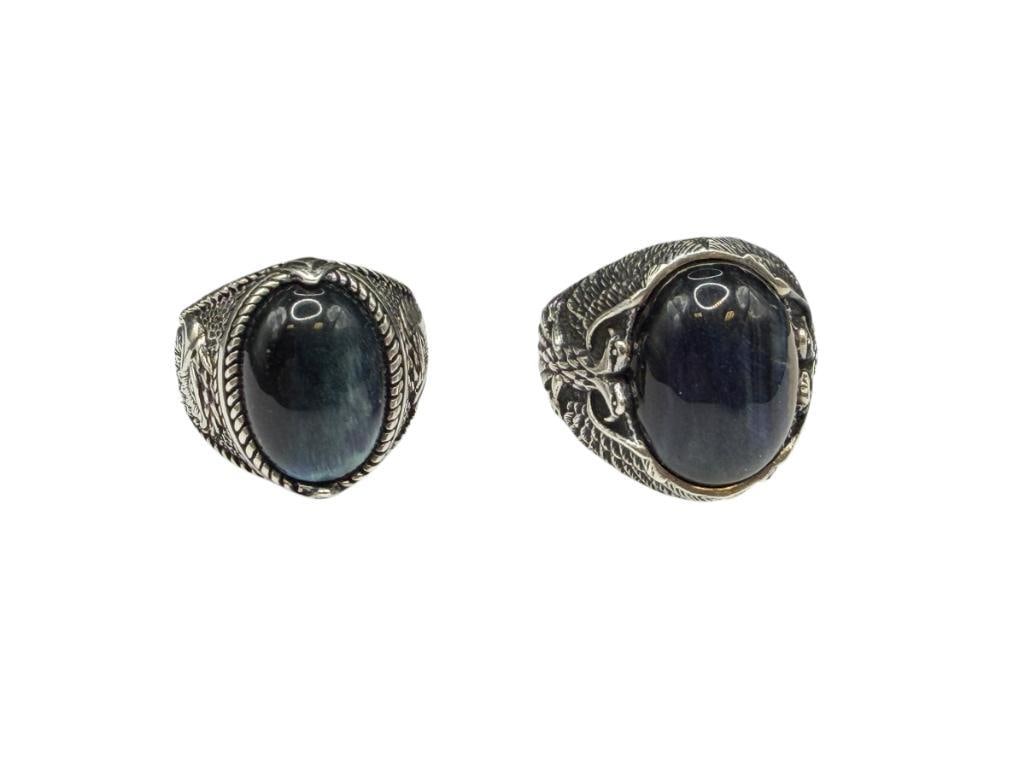 TWO MEN'S STERLING SILVER EAGLE MOTIF BLUE TIGER'S EYE CABOCHON RINGS: BOTH FEATURE EXCEPTIONAL DETAIL OF EAGLE ON SIDES OF RING AND HAVE OVAL CABOCHON BLUE TIGER'S EYE IN CENTER SIZE 11, 1" FRONTS, UP TO 19MM X 14MM TIGER'S EYE, 27.30 GRAMS TOTAL