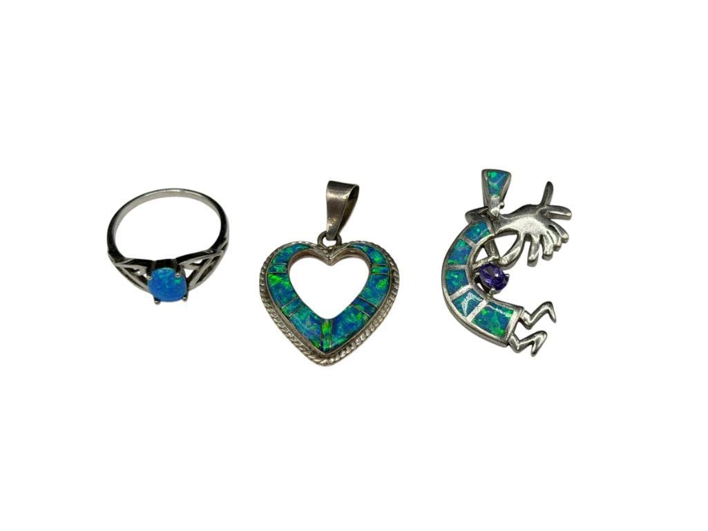 THREE STERLING SILVER OPALITE INLAID JEWELRY PIECES INCLUDING TWO PENDANTS AND A RING: ONE KOKOPELLI PENDANT WITH OVAL CUT AMETHYST CZ, ONE OPEN HEART PENDANT, AND RING FEATURING AN OVAL CABOCHON OPALITE IN CENTER, HEART IS SIGNED BY ARTIST "YR" LARGEST PENDANT IS 1 1/4", SIZE 7 RING, 1