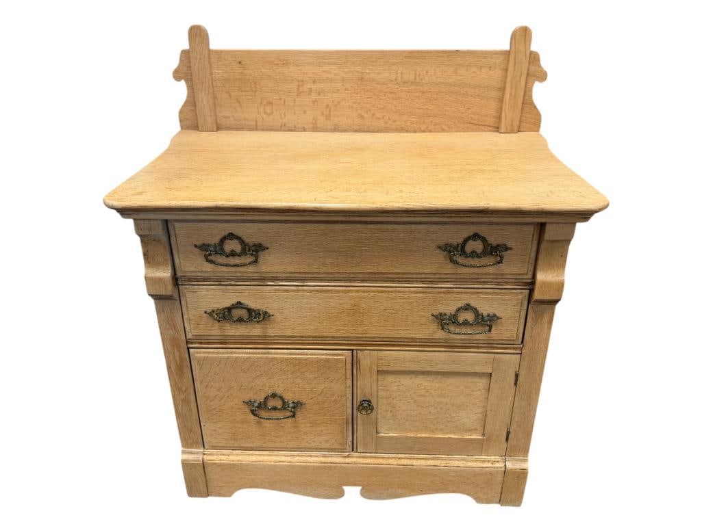 EARLY 20TH CENTURY OAK WASHBOARD CABINET WITH ORNATE BRASS HARDWARE: FEATURES A HIGH BACK SPLASH 34" X 20" X 38"