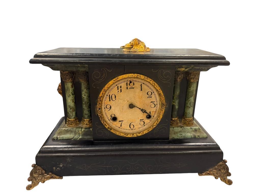 ANTIQUE LEXINGTON FRENCH STYLED MANTLE CLOCK: LION HEAD HANDLES, MARBLE LOOK COLUMNS, ORNATE BRASS FRONT FEET, INCLUDES PENDULUM AND WIND-UP KEY, MISSING GLASS TO NUMERAL DIAL, SHOWS WEAR / AGE, ONE LION HEAD HANDLE NEEDS TO BE NAILED ON 17" X 7"