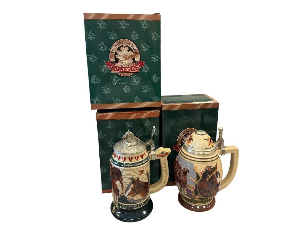 ANHEUSER-BUSCH 2000, 2001, AND 2002 MEMBERSHIP STEINS: BUSCH'S INN, BORN TO GREATNESS, AND LIVING THE LEGACY STEINS, EACH WITH PEWTER FLIP LIDS AND RELIEF DESIGN, IN MINT CONDITION WITH ORIGINAL BOXES 8 1/4", 9", AND 9 1/4" H