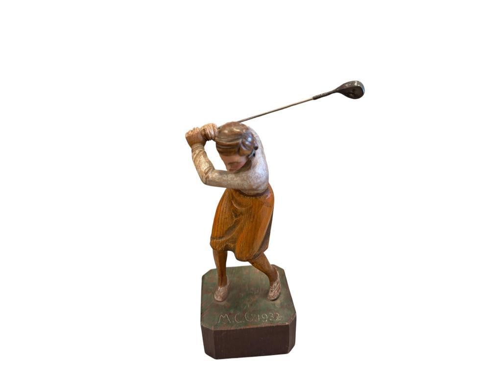 1932 HAND CARVED WOMANS GOLD TROPHY: HAND CARVED WOMANS GOLD TROPHY FEATURING A FEMALE GOLFER SWINGING WITH SILVER DRIVER HALLMARKED, MOUNTED ON A SQUARE SHAPED BASE SIGNED M.C.C. 1932