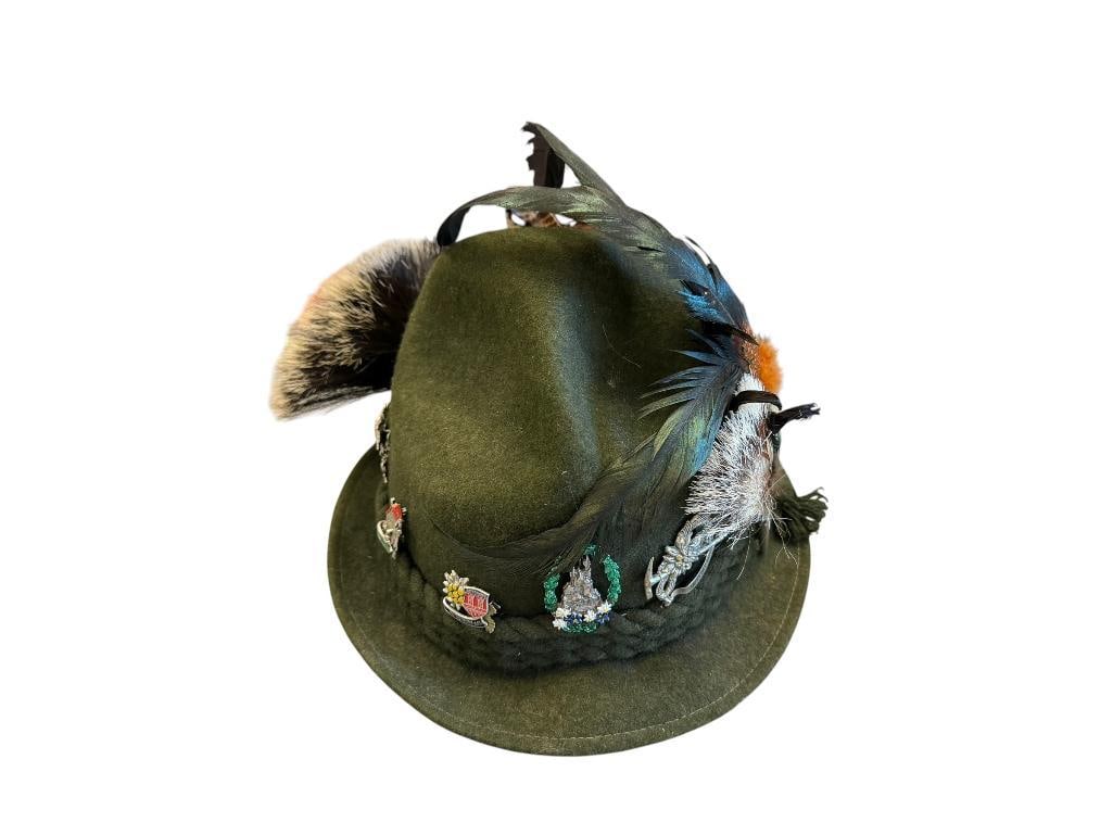 GERMAN TYROLEAN WOOL HAT ADORNED WITH MANY PINS AND FEATHER BRAIDED BAND: INCLUDES PINS FROM VARIOUS CITIES AND LANDMARKS A TOTAL OF 11