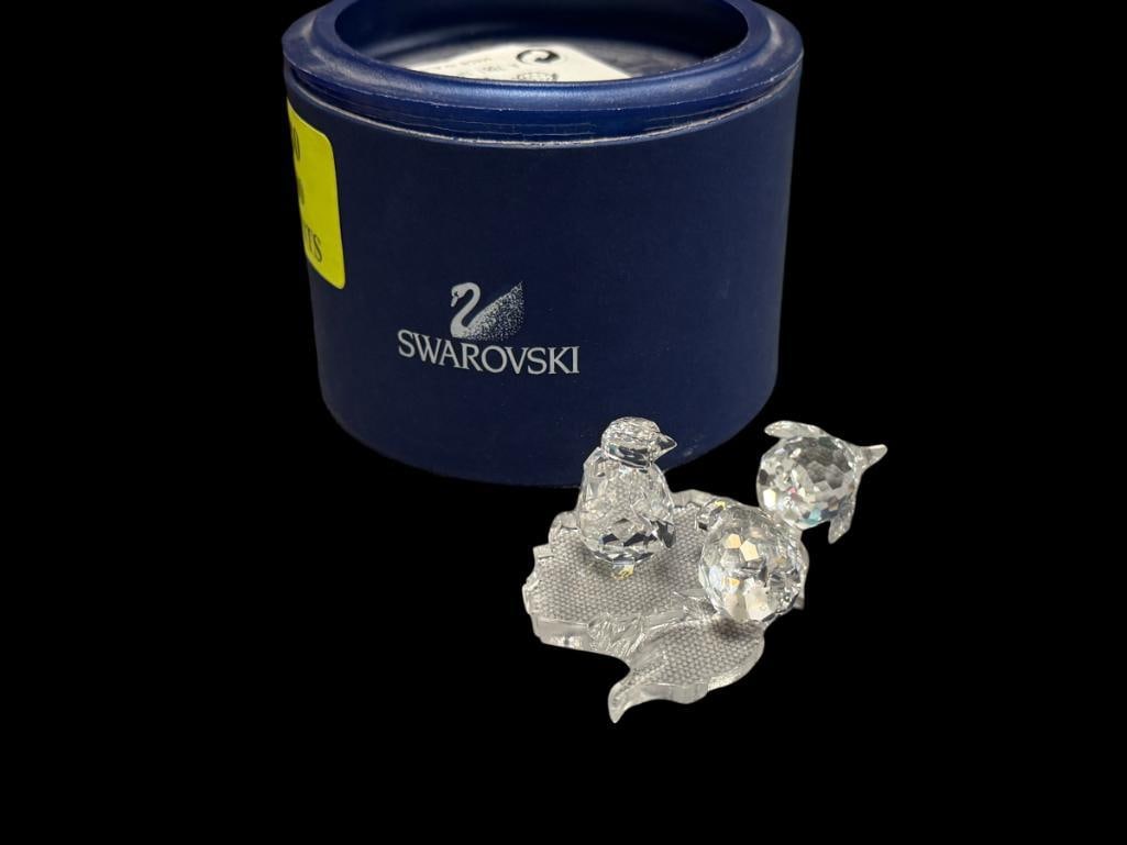 SWAROVSKI CRYSTAL BABY PENGUINS SET OF THREE NO. 7661NR0003 RETIRED 2013: INTRODUCED IN 1997, INCLUDES ANTARCTIC CONTINENT DISPLAY, DESIGNED BY ADI STOCKER, IN MINT CONDITION WITH ORIGINAL BOX 