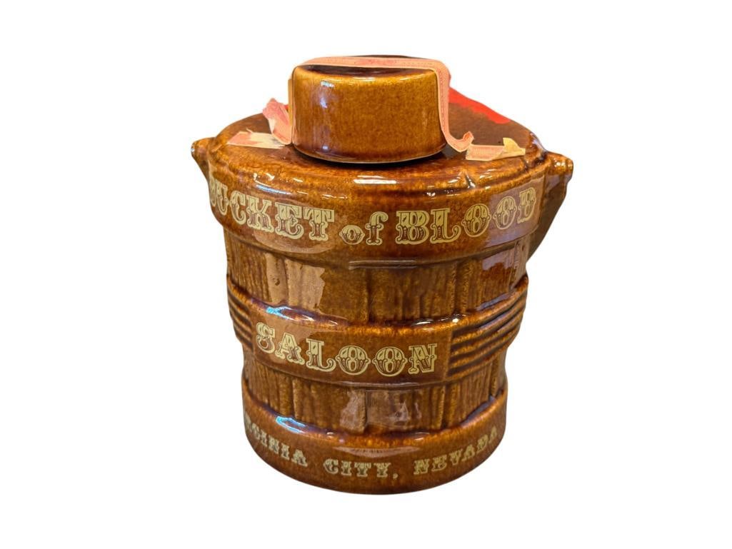 HERITAGE CHINA EZRA BROOKS BUCKET OF BLOOD DECANTER VIRGINA, CITY NV: BUCKET DECANTER WITH BLOOD FOR BUCKET OF BLOOD SALOON IN VIRGINIA CITY, TOP IS PRESENT, BUT CORK IS DAMAGED 6" H