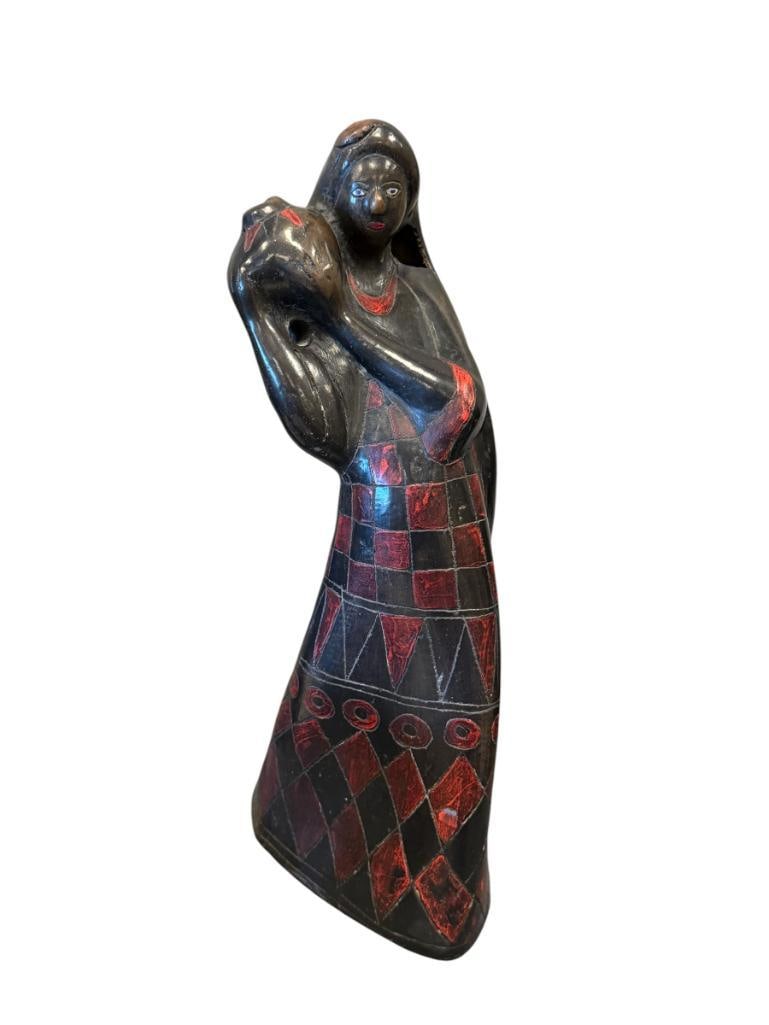 VINTAGE MEXICAN BLACK POTTERY BARRO NEGRO FOLK ART SCULPTURE OAXACA, MX: SCULPTURE DEPICTS WOMAN WITH VESSEL, RED AND BLACK DIAMOND / GEOMETRIC DESIGN ON DRESS, DAMAGED MISSING PIECE ON THE RIGHT SIDE OF HER HAIR 13 3/4" H
