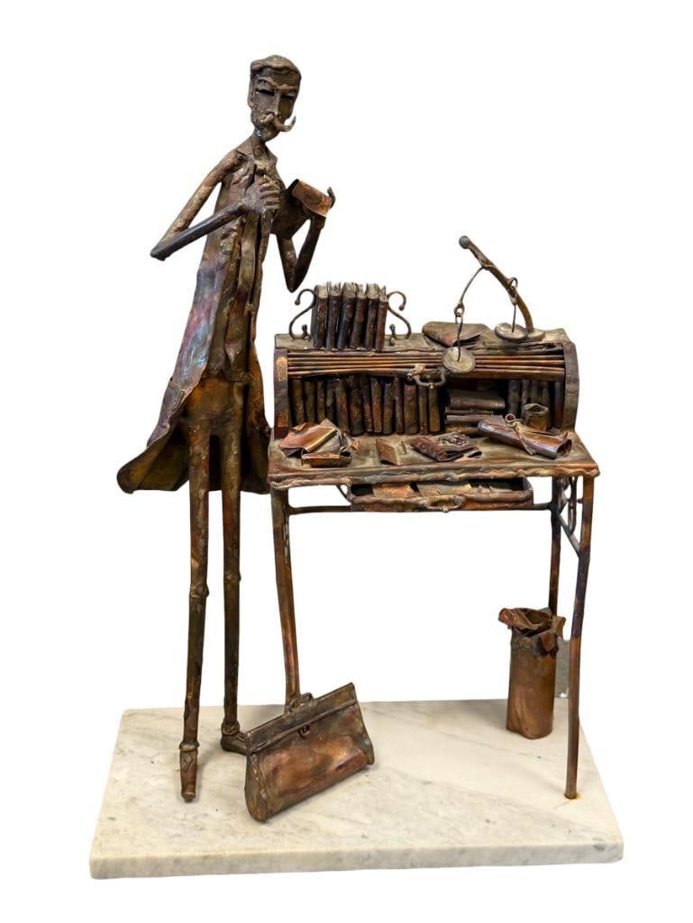MID-CENTURY BRUTALIST SCULPTURE COPPER FIGURINE OF A OCCUPATIONAL MAN POSSIBLY BY JIM LEWK: ELONGATED METAL FIGURE WITH DETAILED MINIATURE ACCESSORIES, BOOKS, DESK, ATTACHE, ETC. MOUNTED ON WHITE MARBLE BASE WITH RED FELT LINED BOTTOM 17 1/4" H