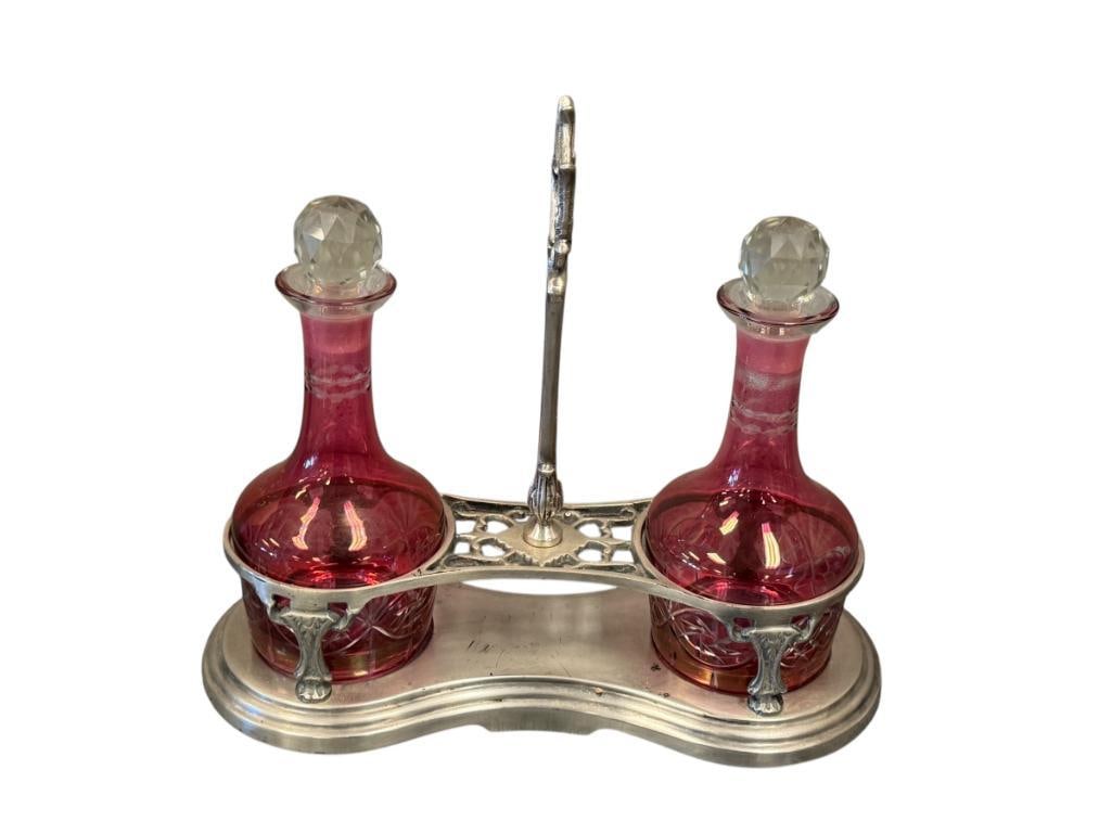 VINTAGE SILVER FINISH DOUBLE CRUET SET WITH CRANBERRY CUT TO CLEAR BOTTLES WITH FACETED STOPPERS: MATCHING SET WITH SILVER FINISH CADDY, NO CHIPS OR CRACKS 8" BOTTLES