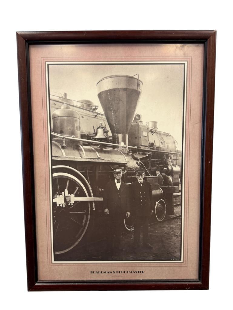 20TH CENTURY PHOTO-PRINT BRAKEMAN AND DEPOT MASTER: DEPICTS BLACK AND WHITE PHOTO-PRINT WITH TWO MEN STANDING IN FRONT OF A LOCOMOTIVE WITH PROMINENT BALLOON STACK, FRAMED 17" X 23" FRAME