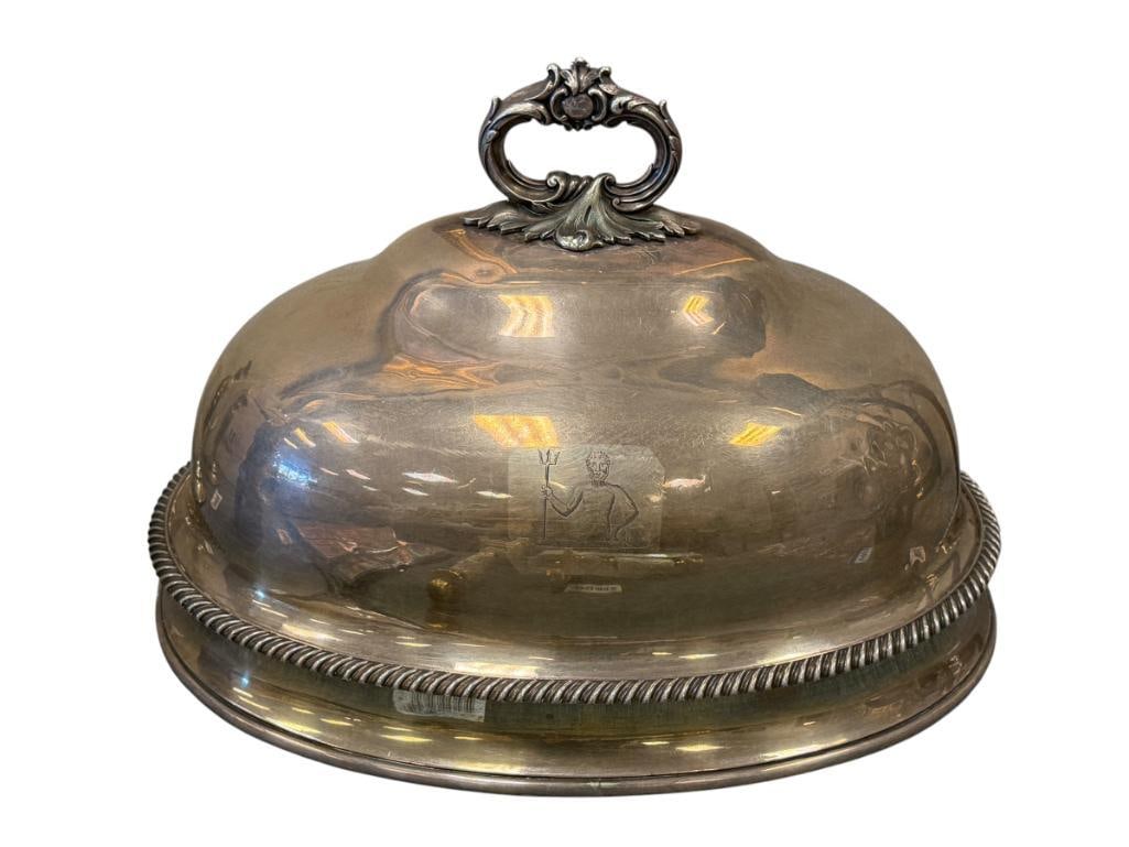 ANTIQUE A.B. SAVORY & SONS HEAVY SHEFFIELD SILVER PLATE MEAT DOME / FOOD CLOCHE: OVAL FOOD DOME WITH ORNATE HANDLE AND GADROONED BASE RIM, WITH ENGRAVED ARMORIAL CREST OF NEPTUNE HOLDING A TRIDENT, HALLMARKED UNDER THE HANDLE, LIGHT SCRATCHES, AND A FEW SMALL DENTS 20" L, 12" H