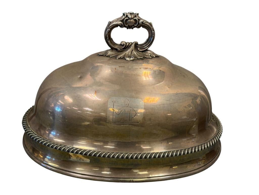 ANTIQUE A.B. SAVORY & SONS HEAVY SHEFFIELD SILVER PLATE MEAT DOME / FOOD CLOCHE: OVAL FOOD DOME WITH ORNATE HANDLE AND GADROONED BASE RIM, WITH ENGRAVED ARMORIAL CREST OF NEPTUNE HOLDING A TRIDENT, HALLMARKED UNDER THE HANDLE, LIGHT SCRATCHES, AND A FEW SMALL DENTS 20" L, 12" H