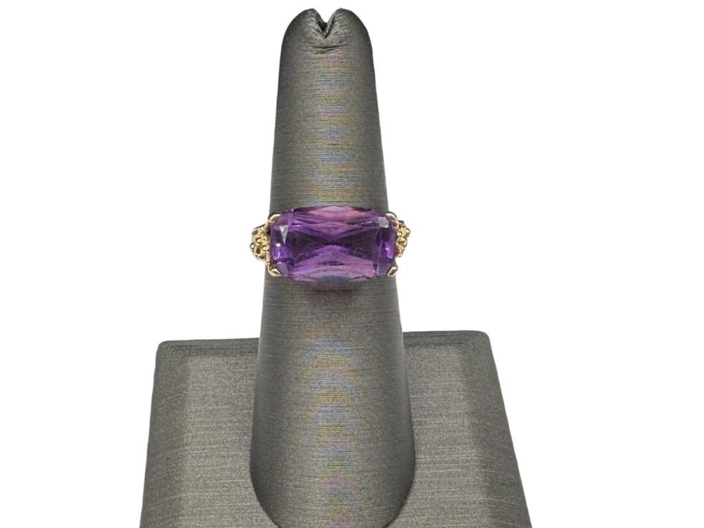 14K YELLOW GOLD CUSHION CUT AMETHYST FASHION RING WITH FIGURAL FLOWER DESIGN ON SHOULDERS OF SHANK: DESIGNER HALLMARKED SIZE 6, 15MM X 9MM AMETHYST, 3.84 GRAMS