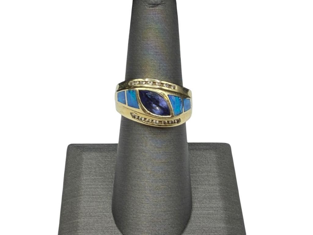 14K YELLOW GOLD MARQUISE CUT TANZANITE, INLAID OPAL, AND ROUND BRILLIANT CUT DIAMOND RING: RING FEATURES A MARQUISE TANZANITE IN CENTER ACCENTED BY INLAID OPAL AND 14 ROUND BRILLIANT CUT DIAMONDS SIZE 6 1/2, 1/2" FRONT, 9.27 GRAMS, 10MM X 5MM TANZANITE, 1MM DIAMONDS