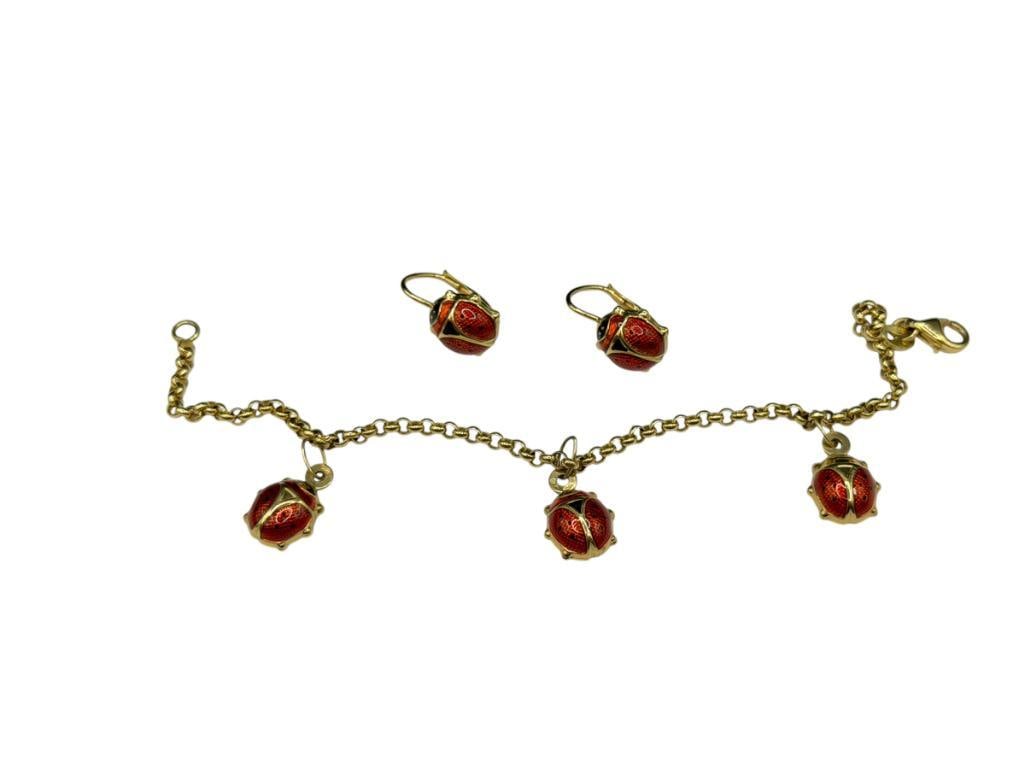MILOR ITALY 18K YELLOW GOLD ENAMELED LADY BUG BRACELET AND EARRINGS SET: EARRINGS HAVE LEVER BACKS AND BRACELET HAS THREE LADYBUG DANGLE CHARMS 7" X 1/8", 1/2" CHARMS, 5/8" EARRINGS, 7.63 GRAMS