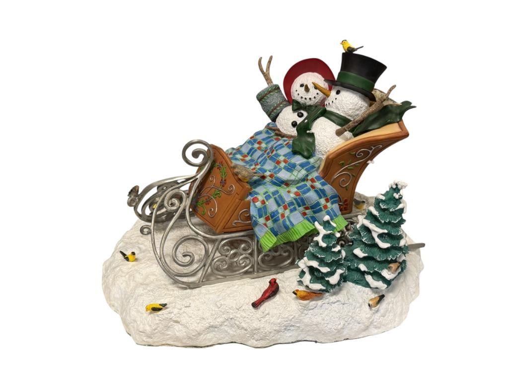 LENOX COZY COMPANIONS CENTERPIECE FIGURINE SNOWMAN COLLECTION BY LYNN BYWATERS: WHIMSICAL HOLIDAY FIGURINE OF SNOWMAN COUPLE IN A SLEIGH WITH SNOWY GROUND, FELT LINED BOTTOM WITH LABEL, NO DAMAGE OR REPAIR, INCLUDES ORIGINAL BOX 11 3/4" L, 8 1/2" H