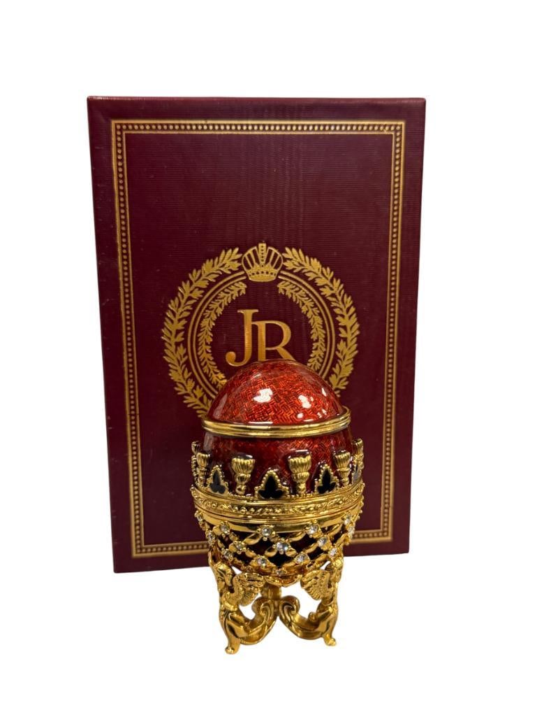 JOAN RIVERS IMPERIAL TREASURES II THE POTPOURRI EGG: BEJEWELED RED ENAMELED EGG WITH GOLD LACE STYLE DESIGN, INCLUDES GOLD FINISH ANGEL BASE, MINT CONDITION WITH CERTIFICATE AND ORIGINAL BOX 3 1/4" H