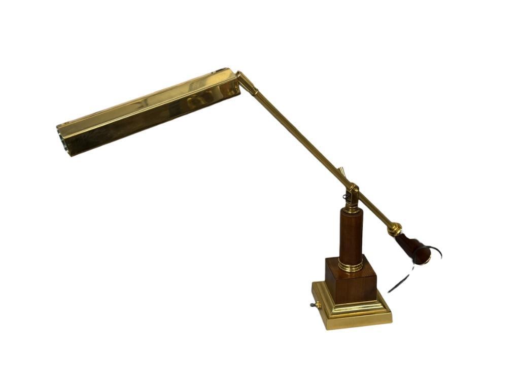 1980'S BALANCED-ARM DESK / PIANO FLUORESCENT LAMP: POLISHED BRASS WITH WOOD ACCENT BASE AND ARTICULATING LAMP HANDLE, POLISHED SQUARE STEPPED BASE, TESTED + 21" H