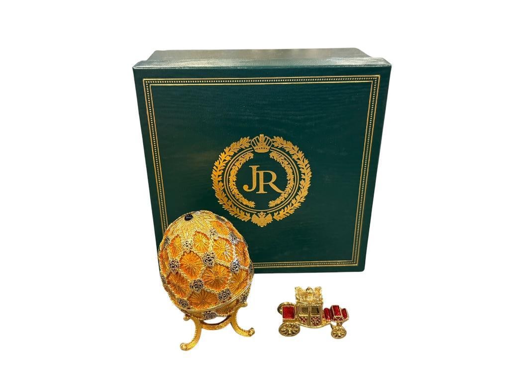 JOAN RIVERS IMPERIAL TREASURES III THE CORONATION EGG: HEAVY GOLD DECORATED EGG WITH THREE FOOTED STAND PLUS ENAMELED AND GOLD FINISH CARRIAGE CHARM, IN MINT CONDITION WITH CERTIFICATE AND ORIGINAL BOX 3 1/2" EGG, 1 5/8" CHARM