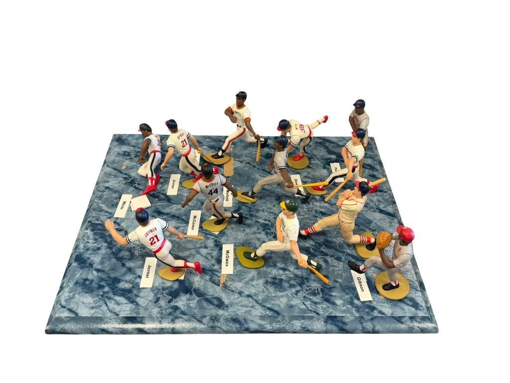 STARTING LINEUPS SMALL ACTION FIGURES OF STAR AND HALL OF FAME PLAYERS 12 TOTAL: INCLUDES WILLIE MAYS, BOB GIBSON, MUSIAL, JOYNER, AND OTHER PLAYERS, ON BLUE MARBLED WOOD PLAQUE 4" FIGURINES