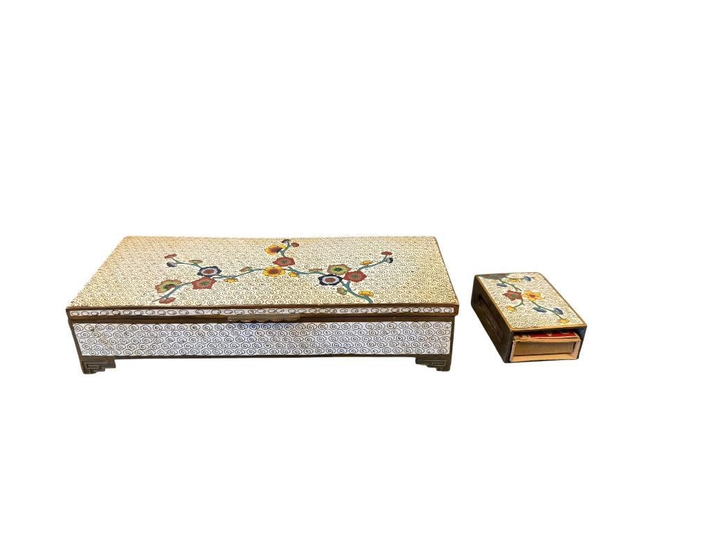 VINTAGE CHINESE CLOISONNE ENAMELED THREE COMPARTMENT TRINKET BOX AND MATCHING MATCHBOX HOLDER: WHITE ENAMELED WITH BRASS WIRE CLOUDS, COLORFUL FLORAL DESIGN ON TOP, BOTH PIECES SHOW AGE 2 3/8" AND 7" L