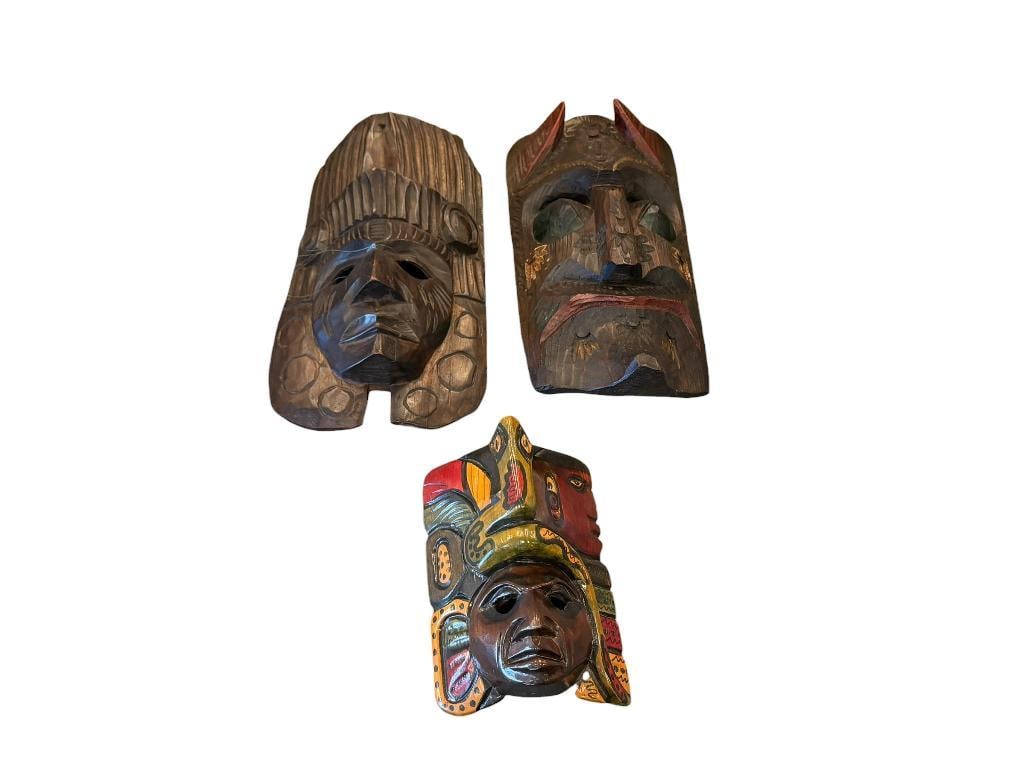 HAND CARVED WOODEN FOLK ART MASKS: THREE CARVED WOOD FOLK ART MASKS INCLUDES MEXICO CARVED WOOD MASK, DEPICTS MAYAN / AZTEC WARRIOR WITH ELABORATE HEADDRESS 8" UP TO 13"