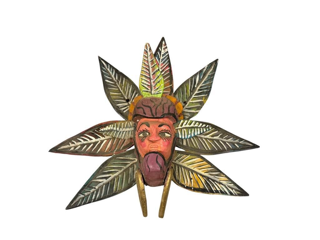 VINTAGE HAND CRAFTED WOODEN LATIN AMERICA MASK: MASK DEPICTS FACE SURROUNDED BY POLYCHROME LEAVES WITHIN A HEADDRESS WITH GOLD ARTICULATING LEAVES BELLOW CHIN 12" H