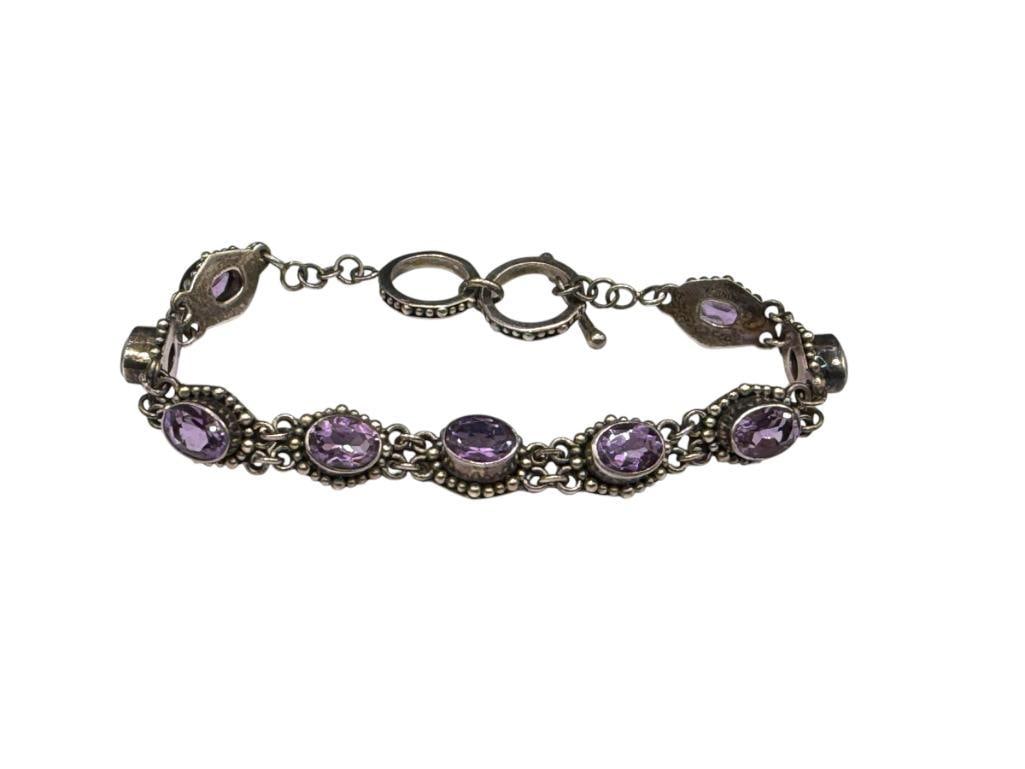 STERLING SILVER OVAL CUT AMETHYST LINK BRACELET: FEATURING TOGGLE CLASP AND NINE OVAL CUT AMETHYSTS 7 1/2" TO 8 1/4" X 3/8", 8MM X 6MM, 17.83 GRAMS