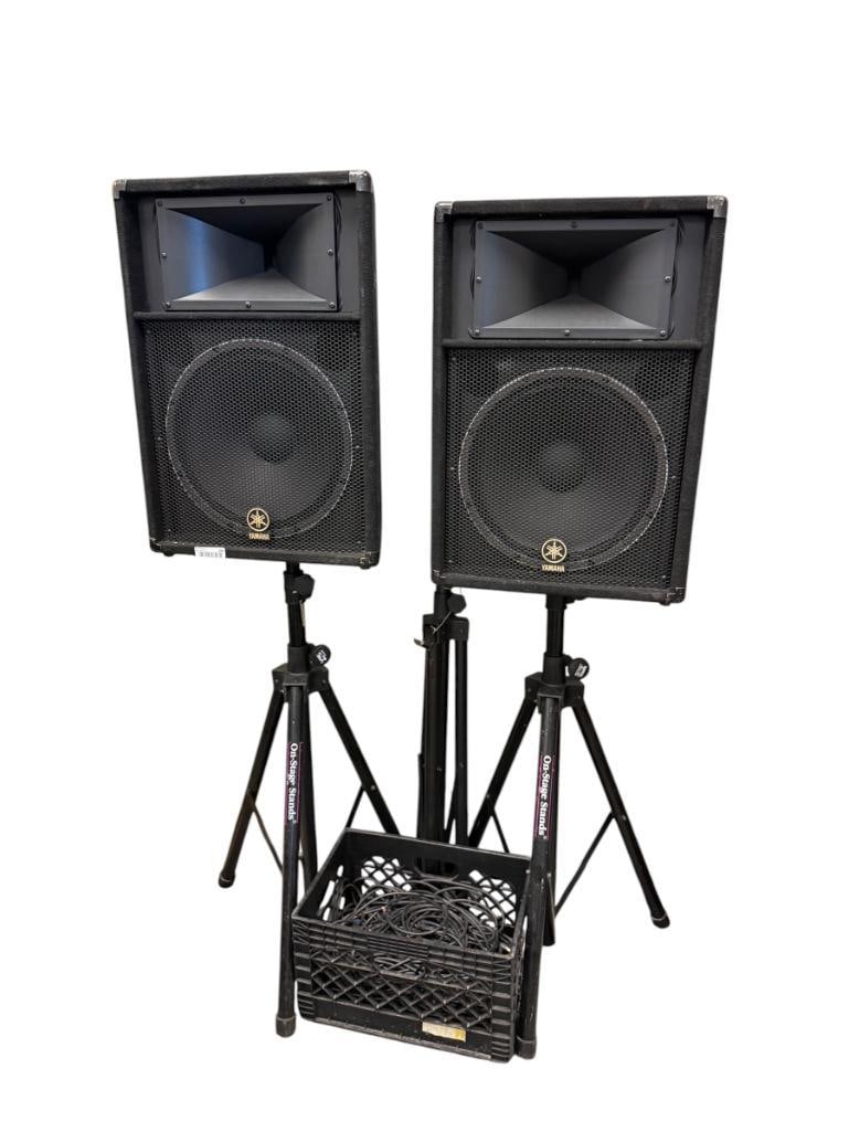 PAIR OF YAMAHA CLUB SERIES V LINE PA SPEAKERS WITH 15 INCH WOOFER AND DRIVER MODEL S115V: INCLUDES ON-STAGE TRI-POD STANDS, INCLUDES EXTRA STAND, DIFFERENT BRAND, AND A CRATE HALF FILLED WITH ASSORTED CABLES / WIRES 19" X 15" X 28" SPEAKERS 