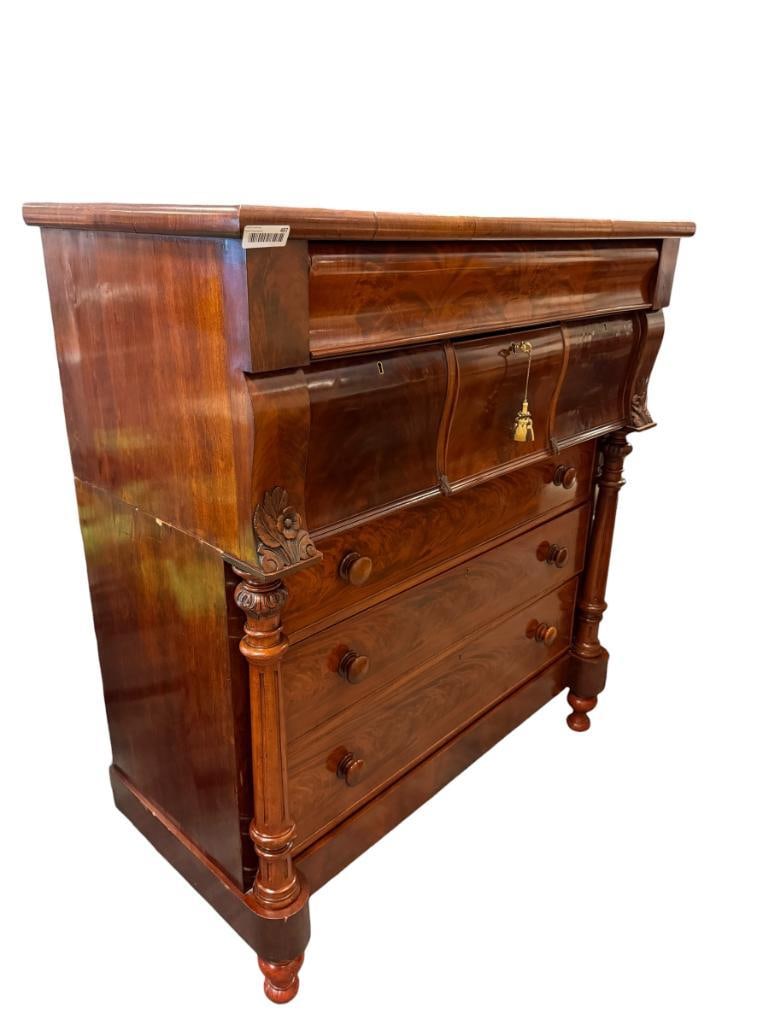 ANTIQUE VICTORIAN SCOTTISH OGEE CHEST OF DRAWERS CIRCA 19TH CENTURY: MAHOGANY RICH WOOD GRAIN WITH TURNED COLUMNS AND CARVED LEAF DETAIL, WATERFALL STYLED FRONT DRAWERS, TWO PIECE UNIT WITH KEY FOR DRAWER LOCKS, BEAUTIFUL PIECE OF FURNITURE WITH MINIMAL WEAR 50"