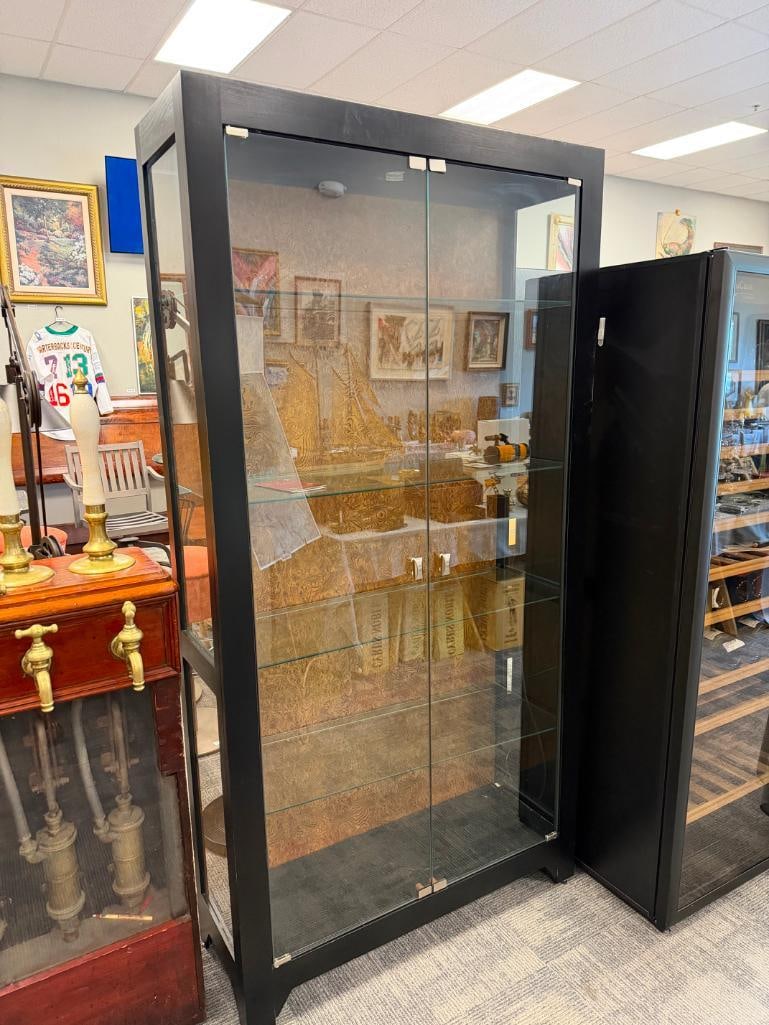HOWARD MILLER ILLUMINATING DISPLAY CABINET WITH GLASS FRONT DOORS AND WOOD GRAIN BACK MODEL. 680-... - 2