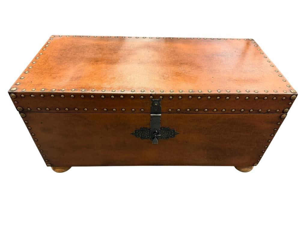 SPANISH STYLED WOOD STORAGE CHEST WITH DISTRESSED VINYL WRAPPED EXTERIOR AND ROUND NAIL HEADS: HINGED TOP WITH DECORATIVE LATCH AND LARGE METAL SIDE HANDLES 39" X 18" X 19"