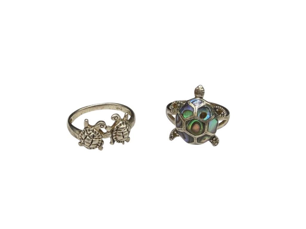 TWO STERLING SILVER TURTLE DESIGN RINGS INCLUDING INLAID ABALONE SHELL DESIGN: OTHER RING FEATURES TWO TURTLES SIZE 6 1/4 AND 5, 4.47 GRAMS TOTAL