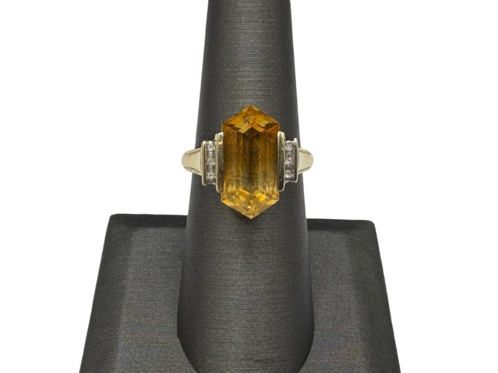 14K YELLOW GOLD TAPERED CUT CITRINE AND ROUND BRILLIANT CUT DIAMOND RING: FEATURING PIERCED GALLERY AND ACCENTED BY SIX DIAMONDS, DESIGNER SIGNED "THL" SIZE 7, 16MM X 8MM CITRINE, 1MM DIAMONDS, 5.49 GRAMS