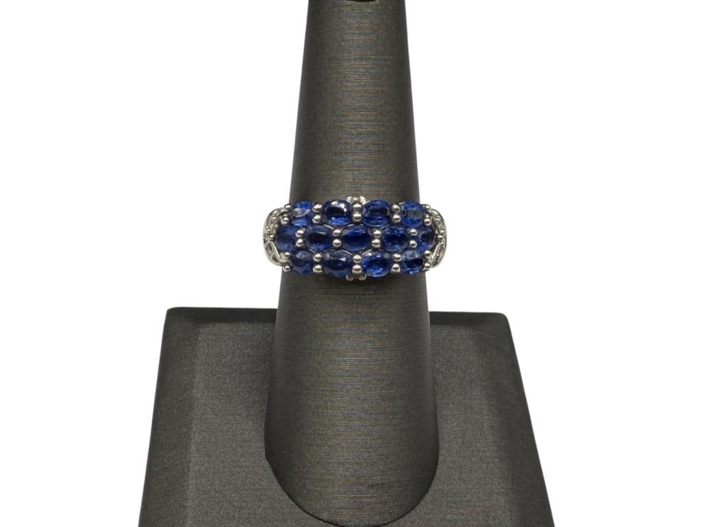 STERLING SILVER DESIGNER HALLMARKED IOLITE AND WHITE TOPAZ RING: FEATURING A CLUSTER OF OVAL CUT IOLITES ACCENTED BY ROUND CUT WHITE TOPAZ, MARKED "THAILAND" SIZE 7, 3/8" FRONT, 5.21 GRAMS, 4MM X 2.5MM IOLITES
