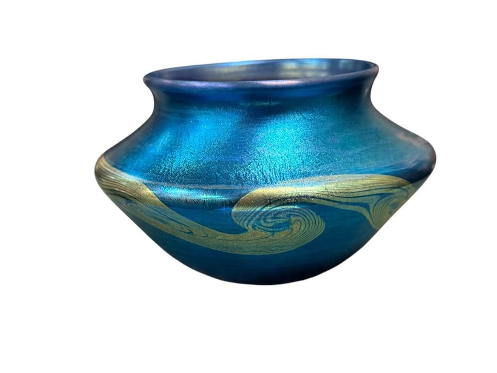 TIFFANY STUDIOS TGDCO FAVRILE GLASS CO. IRIDESCENT HAND BLOWN ART GLASS BOWL ART NOUVEAU STYLED: COBALT BLUE AND PURPLE IRIDESCENT ART GLASS BOWL WITH SCROLL ART DESIGN BAND, ORIGINAL LABEL ON THE BOTTOM, HAS STAIN MARK FROM OTHER LABEL ON THE BODY, NO CHIPS OR REPAIRS 4 3/4" ROUND, 3 1/8" H