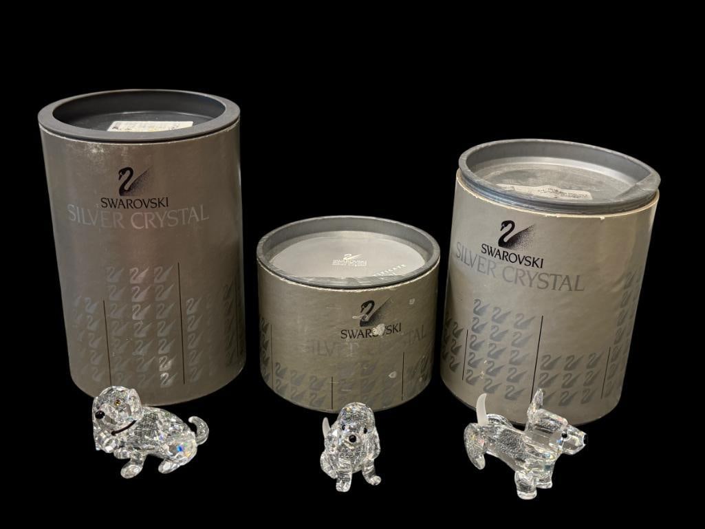 SWAROVSKI CRYSTAL THREE FACETED DOG FIGURINES 7619NR001 / NR002 / NR006: TWO WITH FROSTED TAILS, ALL IN NEAR MINT CONDITION WITH ORIGINAL STORAGE TUBES, ONE INCLUDES CERTIFICATE BOOKLET, NO CHIPS OR REPAIRS APPROX. 1 1/2" H