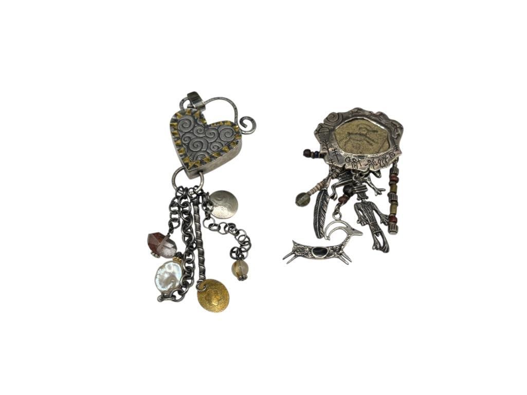 TWO ARTISAN MADE STERLING SILVER DANGLE CHARM PENDANTS: BOTH FEATURE UNIQUE DESIGNS WITH DANGLING CHARMS LARGEST IS 5", 47.78 GRAMS TOTAL