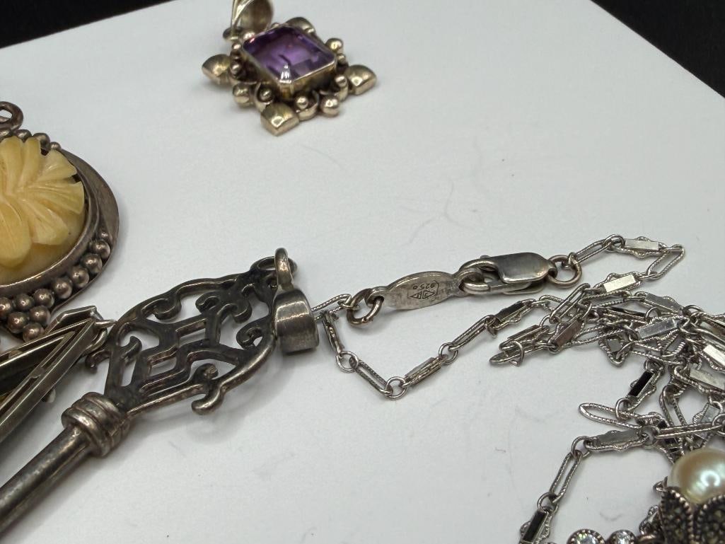 ASSORTED JEWELRY FEATURING MOSTLY STERLING SILVER PENDANTS - 12