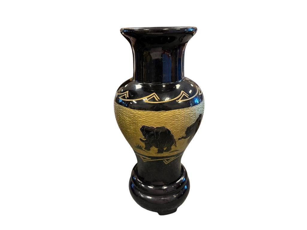 VINTAGE BLACK LACQUERED WOODEN VASE HAND CARVED ELEPHANT MOTIF WITH GOLD ACCENTS: FOOTED VASE WITH HERD OF ELEPHANTS ACCENTED IN GOLD, MADE IN VIETNAM 9 3/4" H