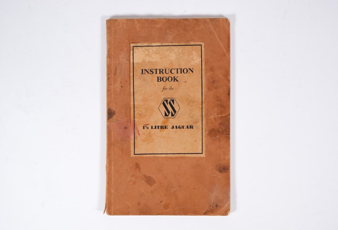 SS/JAGUAR: An original 'INSTRUCTION BOOK for the SS 1.5 LITRE JAGUAR'. Circa late 1930's: SS/JAGUAR: An original 'INSTRUCTION BOOK for the SS 1.5 LITRE JAGUAR', 69 pages of care and maintenance procedures, carded covers; book with some foxing, small paper loss to title page.