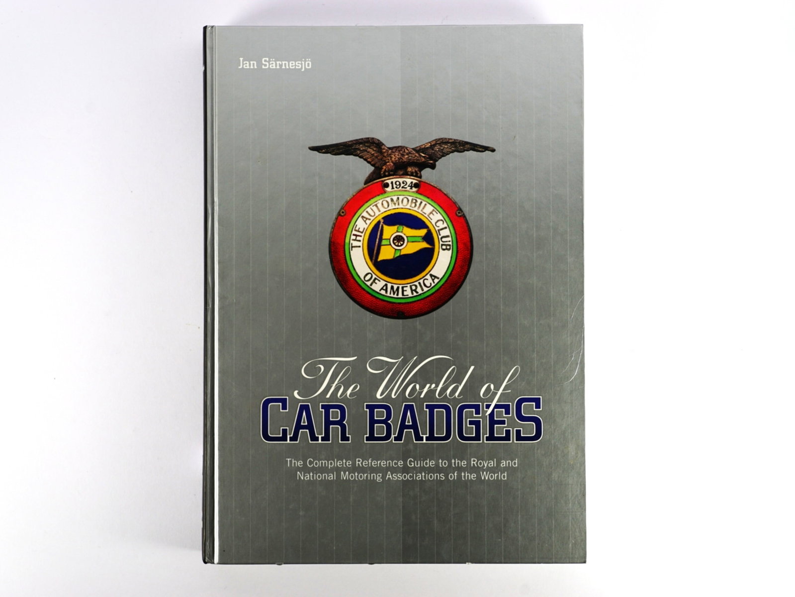CAR BADGES: 'The World of Car Badges' by Jan Sarnesjo. First Edition: CAR BADGES: 'The World of Car Badges' by Jan Sarnesjo, first edition published by Darwin Books 2003, 328 numbered pages, a well-illustrated reference title; slight shelf wear to covers.