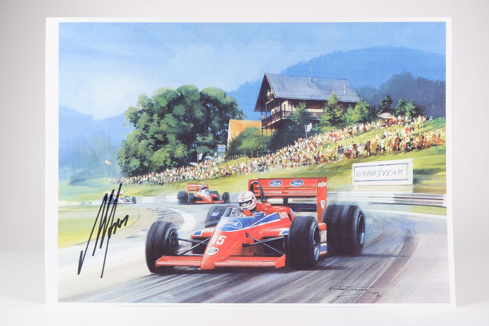 JONES: An image featuring the 1986 Beatrice-Lola THL1 Hart of Alan Jones. Alan Jones signature: JONES: A reproduced image of artwork by Michael Turner featuring the 1986 Beatrice-Lola THL1 Hart of Alan Jones, image signed by Jones in black marker; on thick stock paper, image measures 29.5cm wide