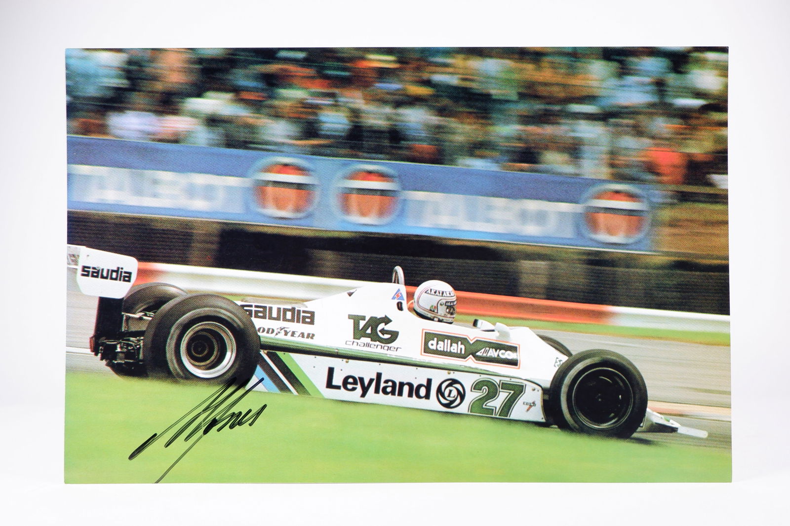 JONES: A colour image of Alan Jones racing the Williams FW07B at the 1980 British G.P. A.J signature: JONES: A colour image of Alan Jones racing the Williams FW07B at the 1980 British Grand Prix, image signed by Jones; on photographic paper, image measures approximately 30cm wide, 19.5cm high overall.