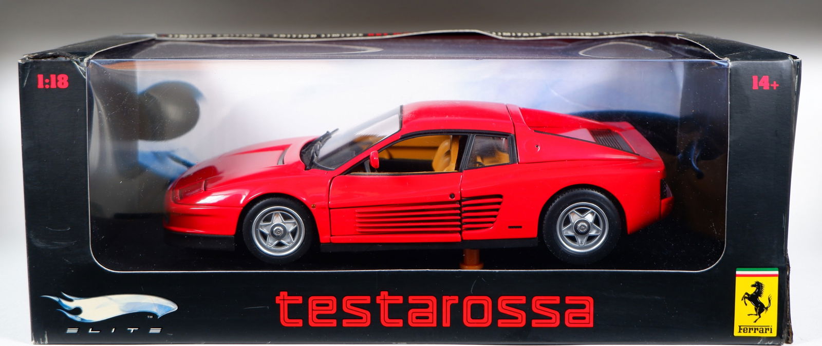 TESTAROSSA: A 1:18 scale HOT WHEELS 'ELITE' 1984 Ferrari Testarossa (J2928). Red: TESTAROSSA: A 1:18 scale HOT WHEELS 'ELITE' 1984 Ferrari Testarossa (J2928), red, tan interior, opening features, engine detail, steerable wheels; with original outer box, model attached to stand; she