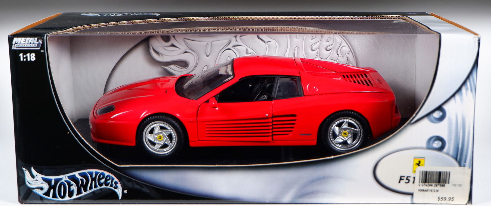 F512M: A 1:18 scale HOT WHEELS Ferrari F512M Testarossa: F512M: A 1:18 scale HOT WHEELS Ferrari F512M Testarossa, red, black interior, opening features, engine detail, steerable wheels; with original outer box, model attached to stand.