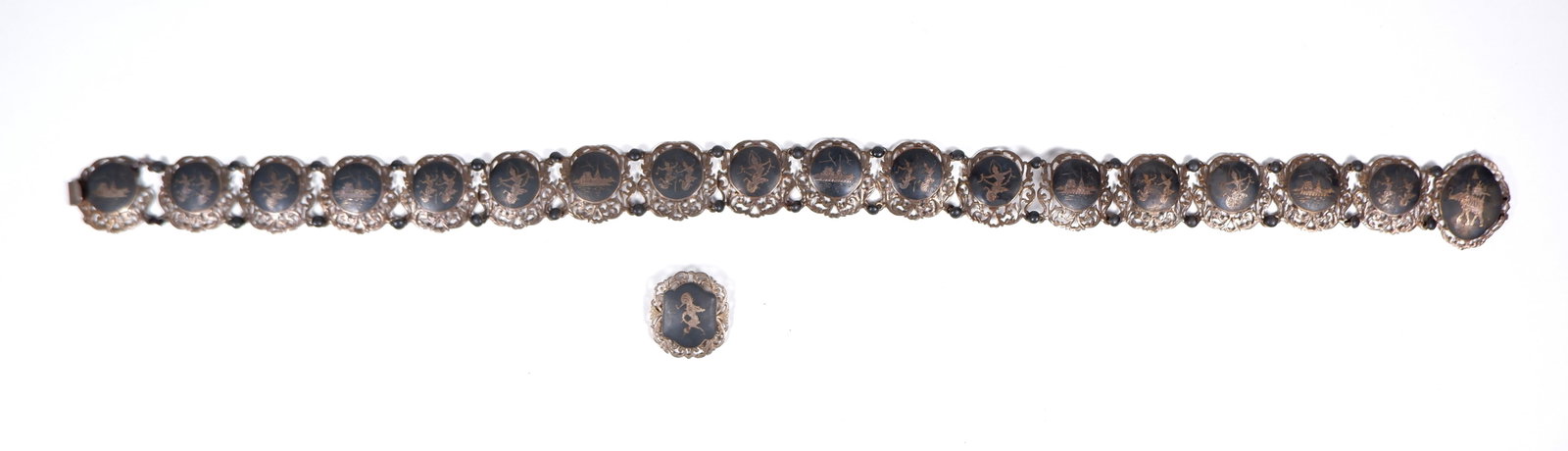 A reticulated Siam silver and black enamel panelled belt and brooch, circa 1950s: total silver weight 164gms, marked sterling to back. Condition .