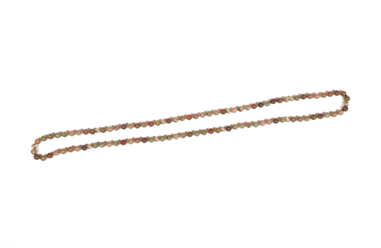 A strand of polished unakite beads with fluted gold bead rondels: the hand knotted strand with ten 9ct gold fluted roundels Condition .