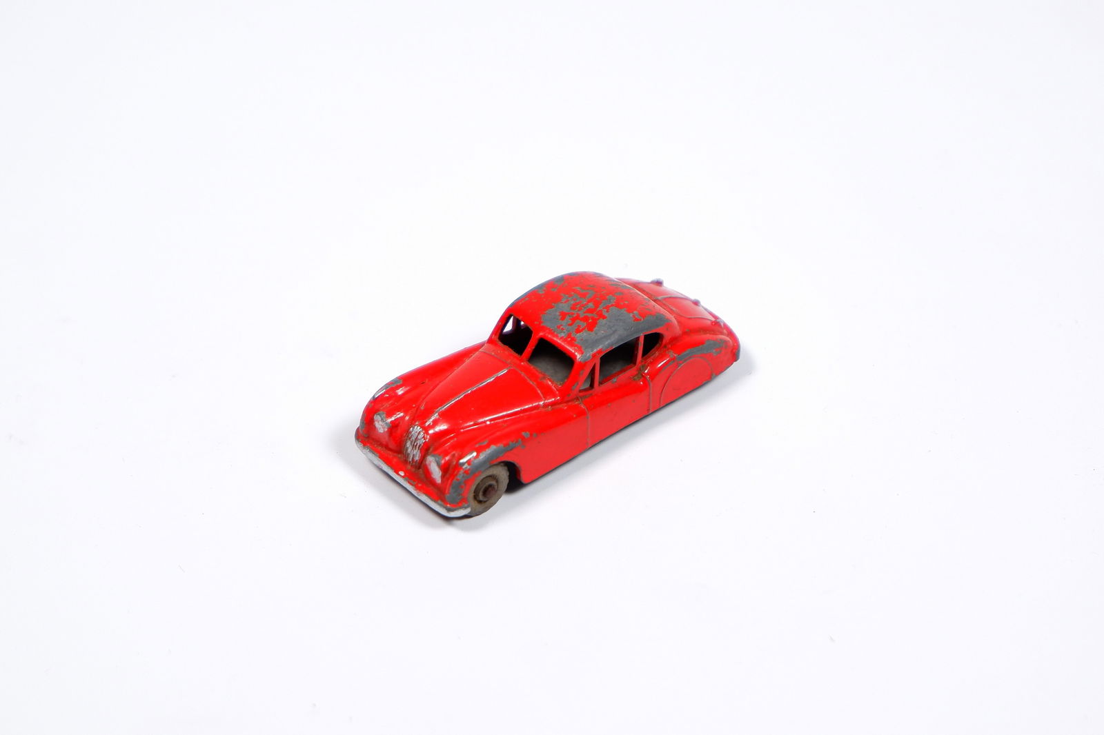 JAGUAR: A Matchbox Regular Wheels Jaguar XK140 in red: JAGUAR: A Matchbox Regular Wheels Jaguar XK140 in red, grey plastic wheels, black base; paint loss to model.