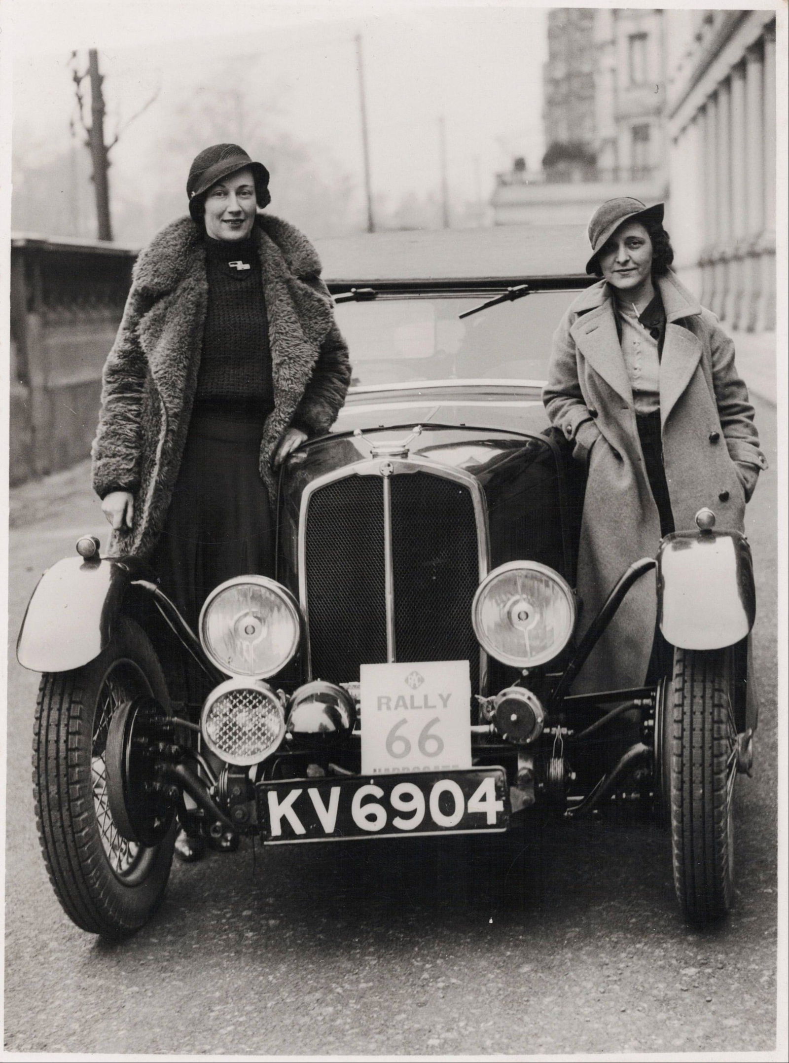RAC RALLY: Image of Richmond & Gordon-Smith posed beside a Triumph, 1936 R.A.C Rally: RAC RALLY: An original black and white image of Joan Richmond and Eva Gordon-Smith posed beside the Triumph Open Tourer in which competed during the 1936 R.A.C Rally, reverse stamped ‘BARRATT'S